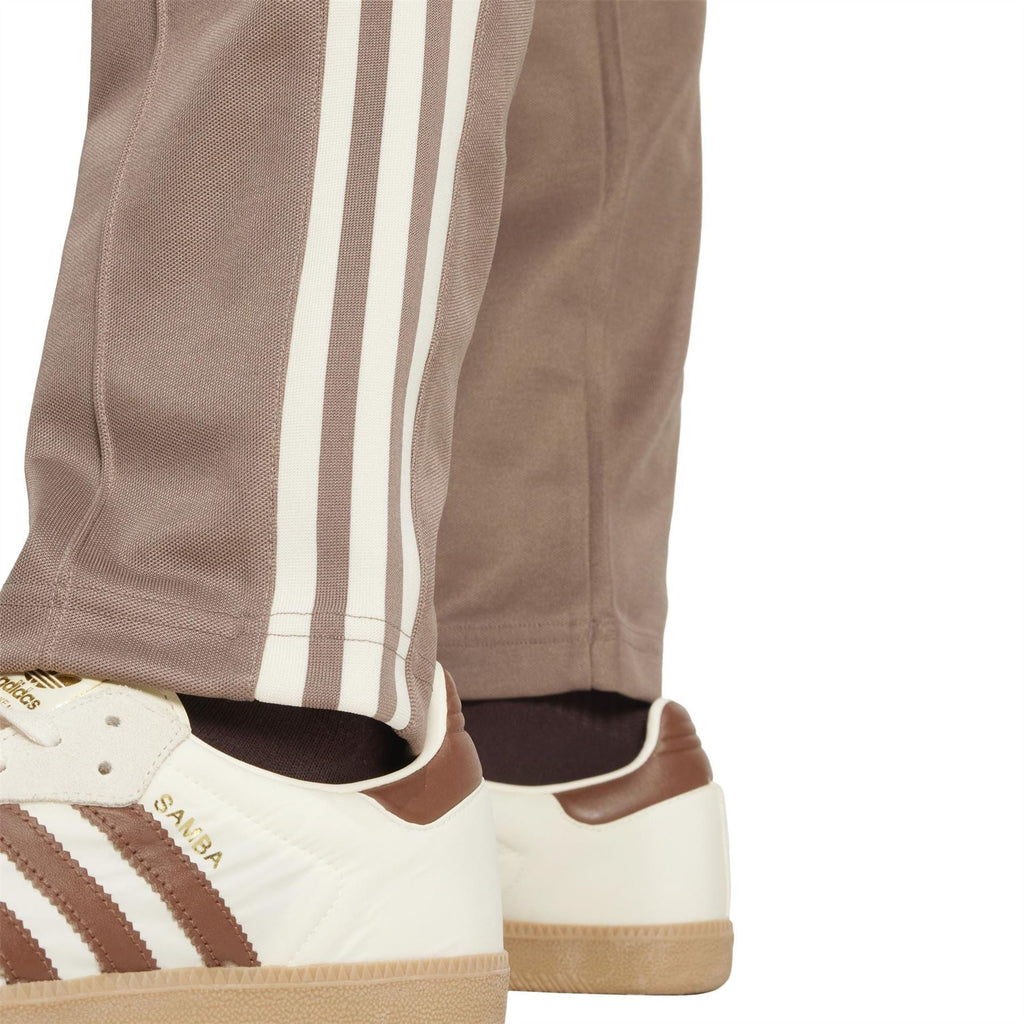 adidas Originals track pants cuff view, trace brown with white triple stripe panel