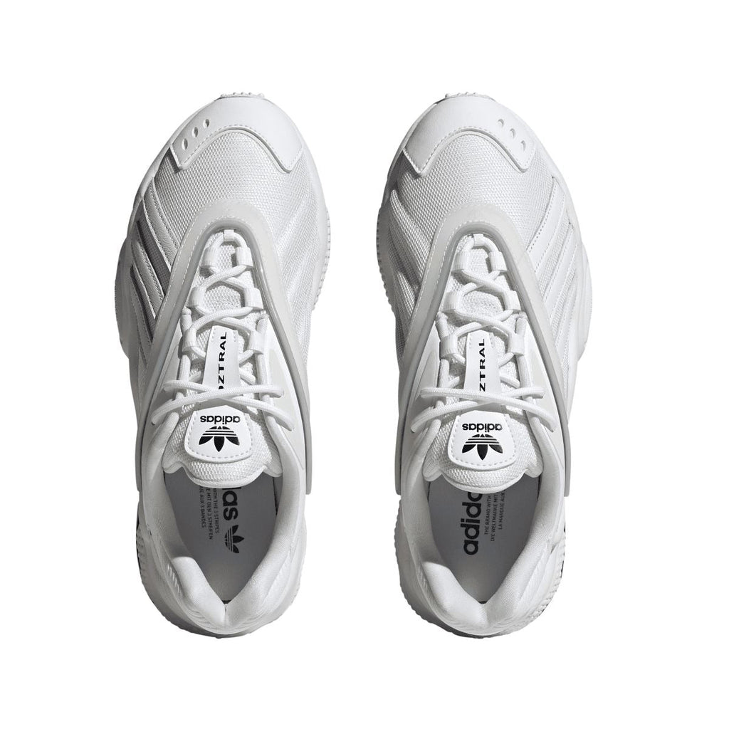 Pair of white adidas Originals Oztral trainers, top view with laces and adidas logo