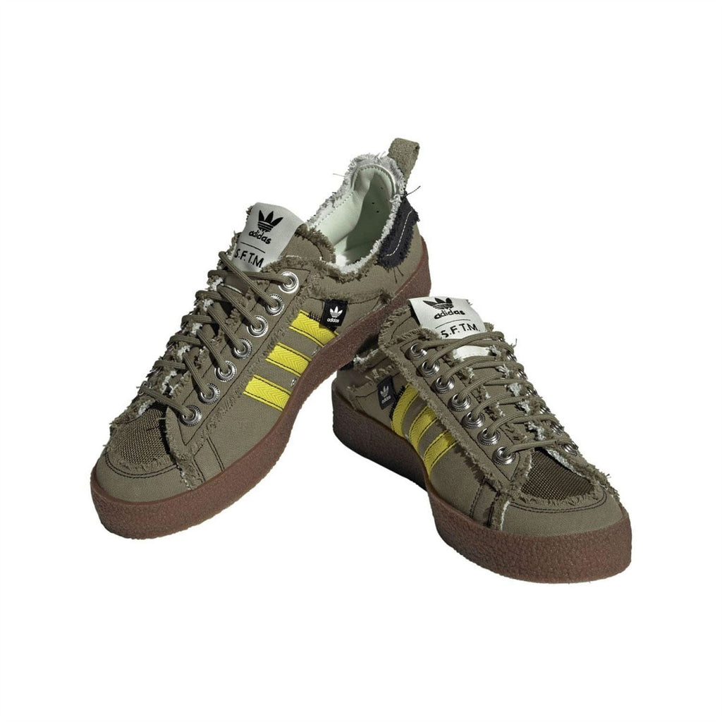 Olive trainers pair view with yellow Three Stripes, lace-up closure, and brown rubber sole