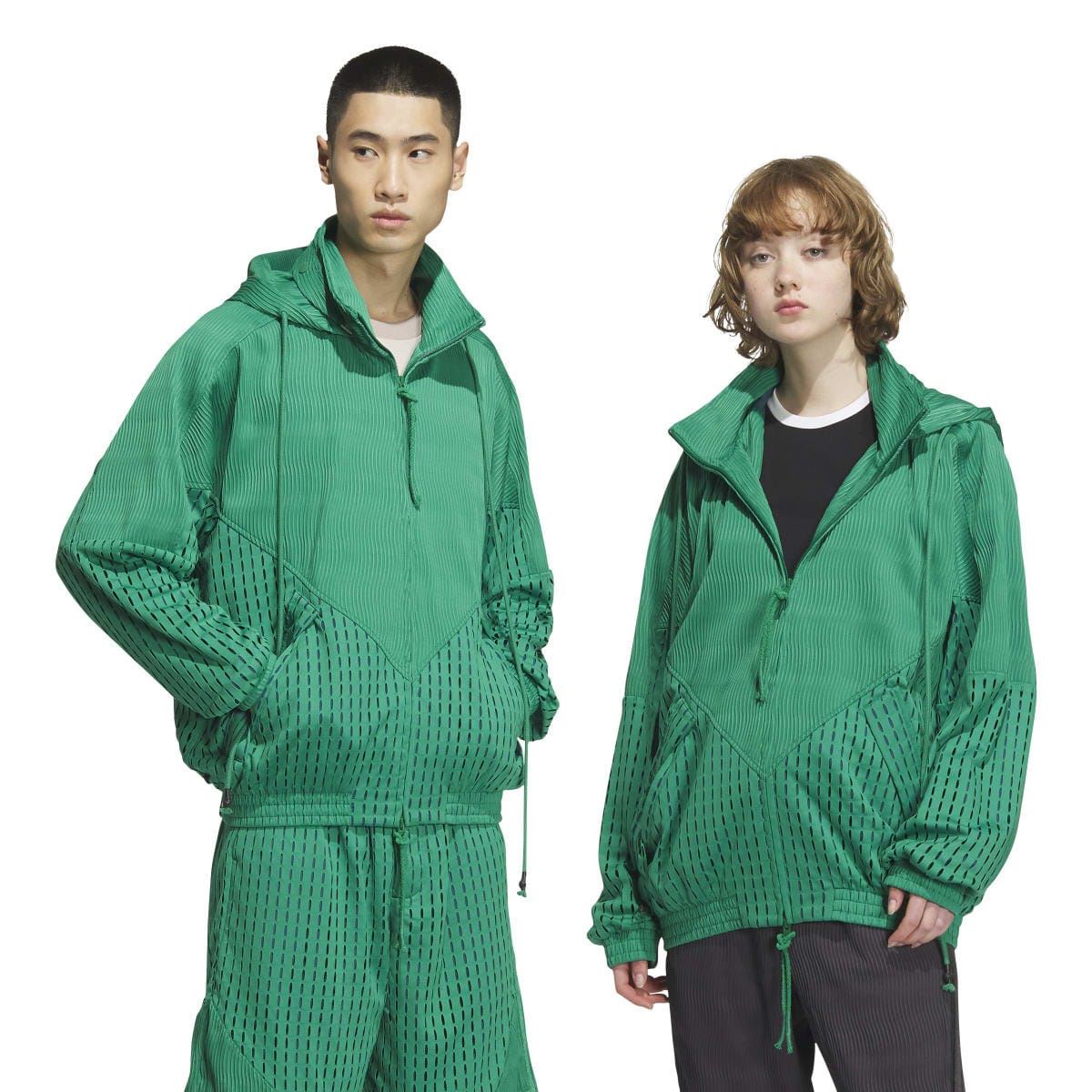 Green hooded zip jacket on two models with perforated panels and ribbed waistband