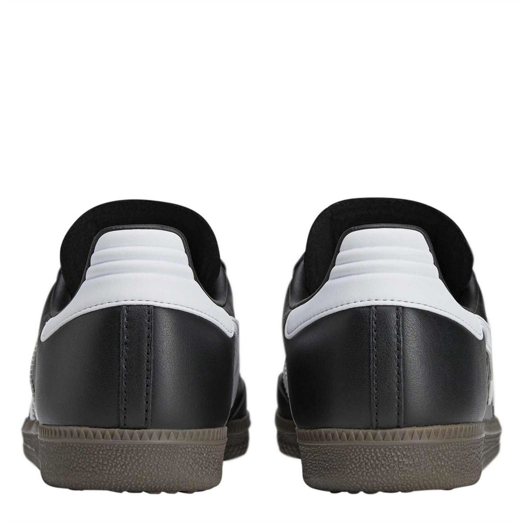 Black low-top sneakers with white heel accents and textured rubber outsole