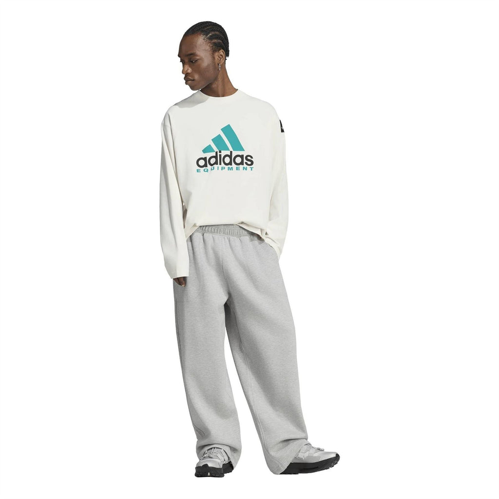 Off-white long-sleeve top with teal adidas Equipment logo, worn with joggers