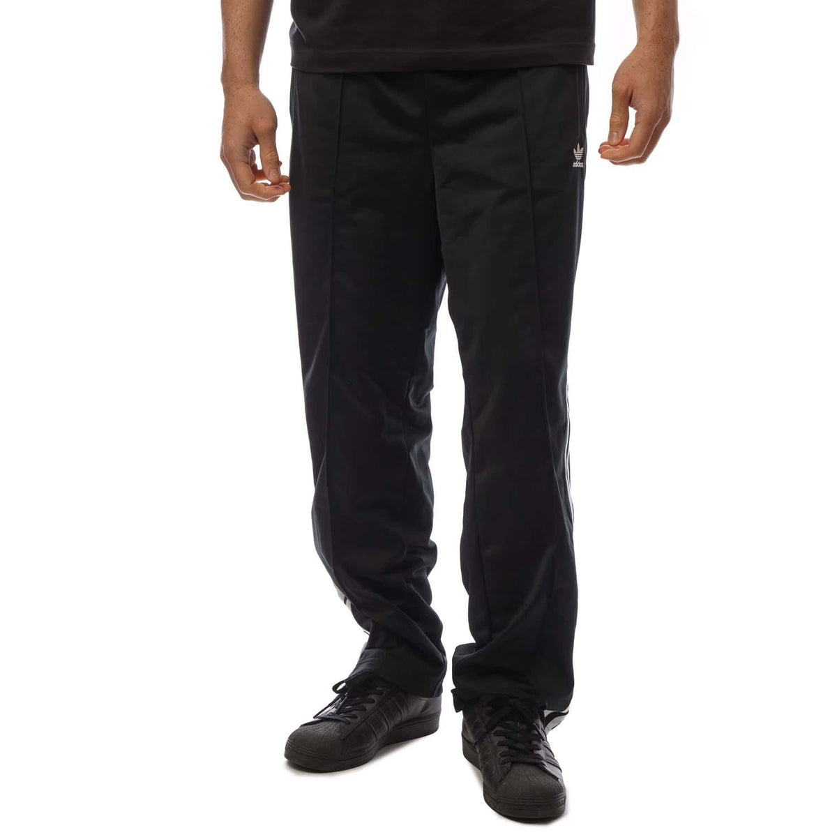 Black track pants with straight leg and white side stripe detailing