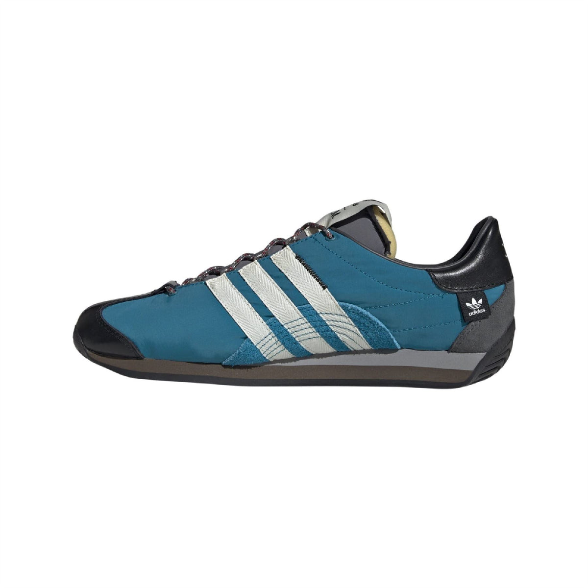 Teal lace-up trainers with white three stripes, black heel and gray suede toe panel