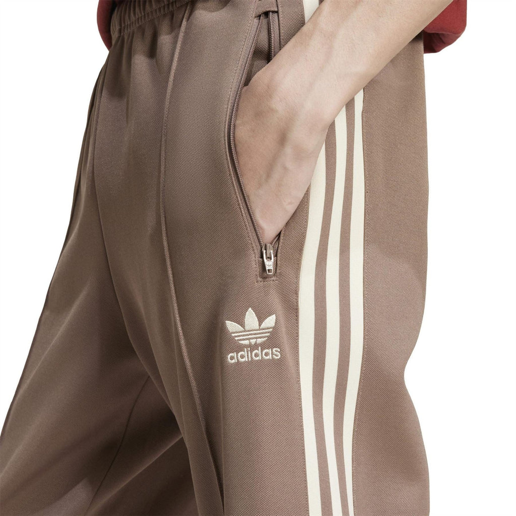 adidas Originals track pants front detail, trace brown with adidas logo and side stripe panel