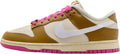 Low-top sneakers with gold suede, white swoosh, pink laces, and cream sole