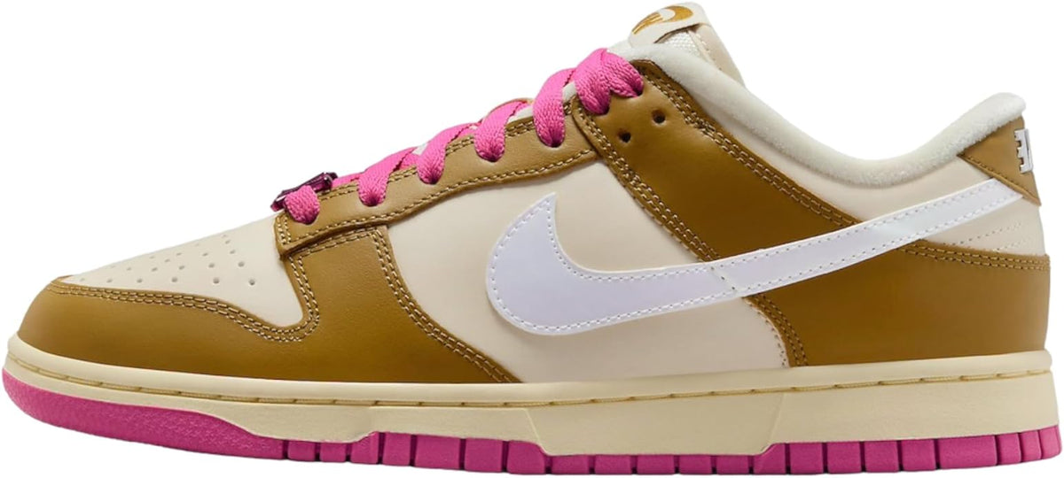 Low-top sneakers with gold suede, white swoosh, pink laces, and cream sole