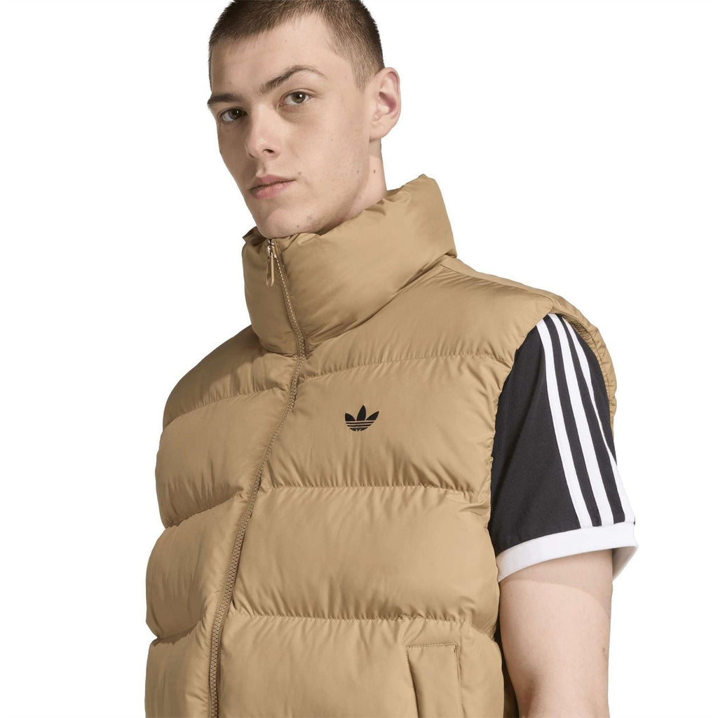 Tan puffer vest with adidas trefoil logo on chest, stand collar zip