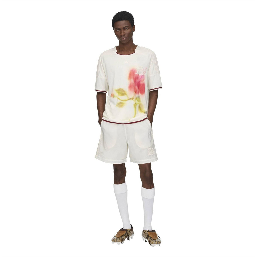 White football jersey with floral watercolor print and burgundy trim, worn with matching shorts