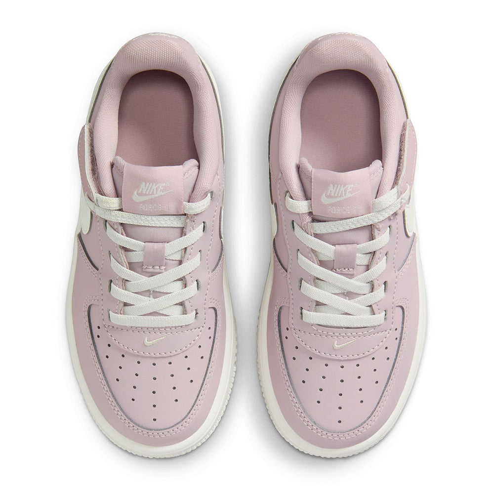 Kids sneakers top view with rose uppers, white laces, and perforated toe box
