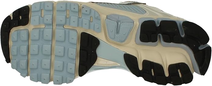 Nike Zoom Vomero 5 outsole tread with light blue traction pods and black rubber sections.