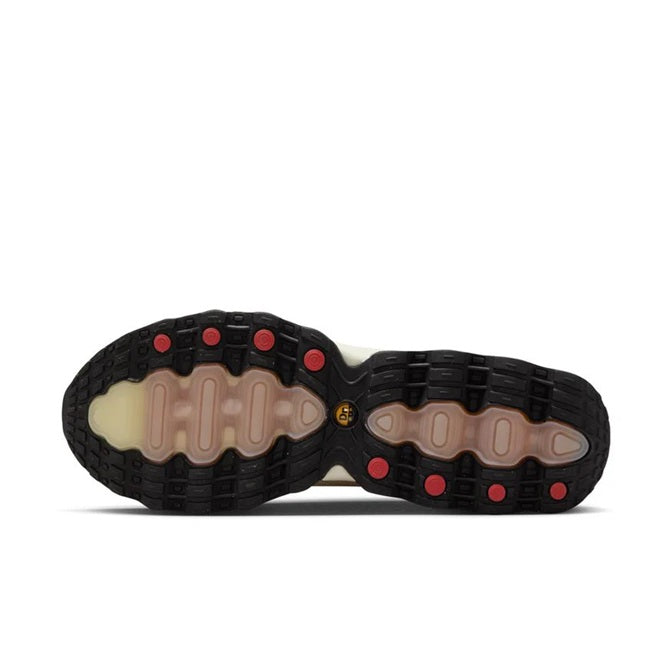 Light khaki sneakers shown from bottom with black rubber outsole and red traction dots