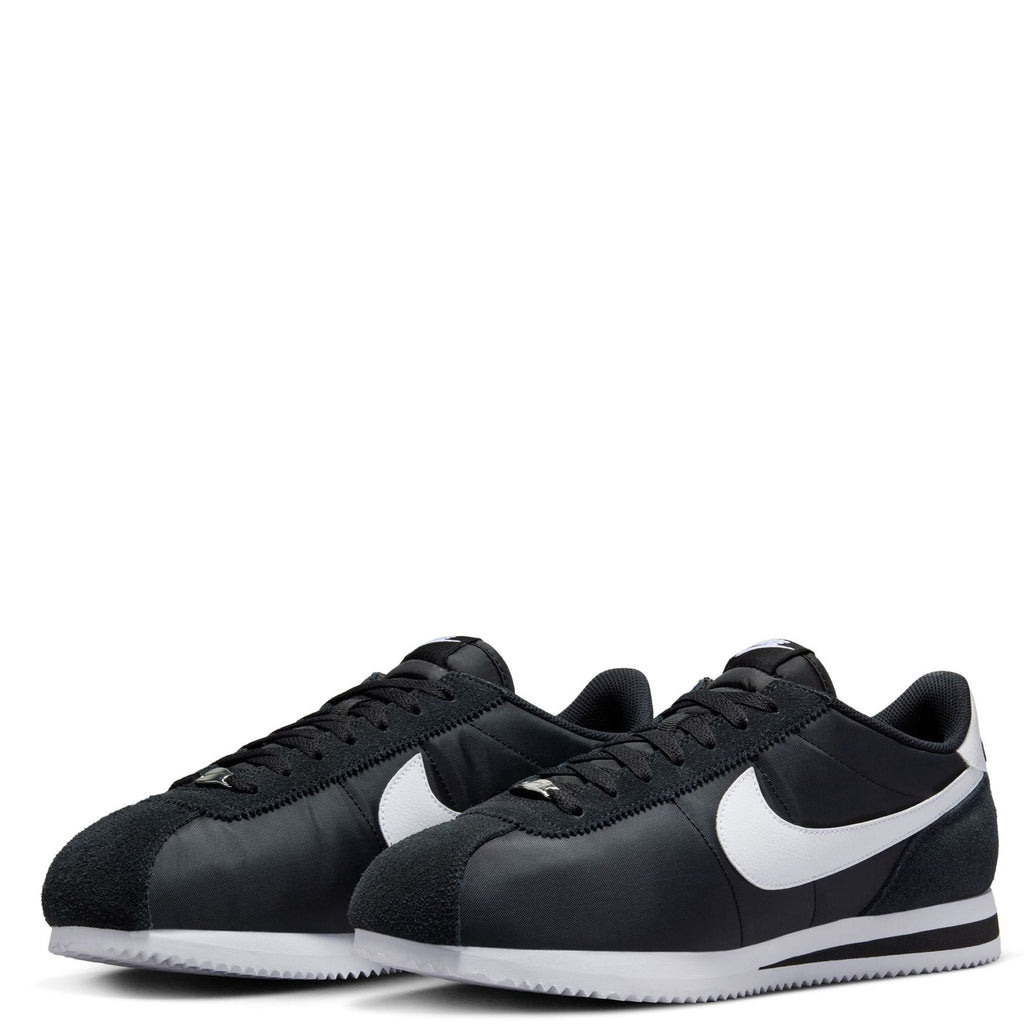 Men's Nike Cortez TXT sneakers, black uppers with white swoosh, lace-up pair