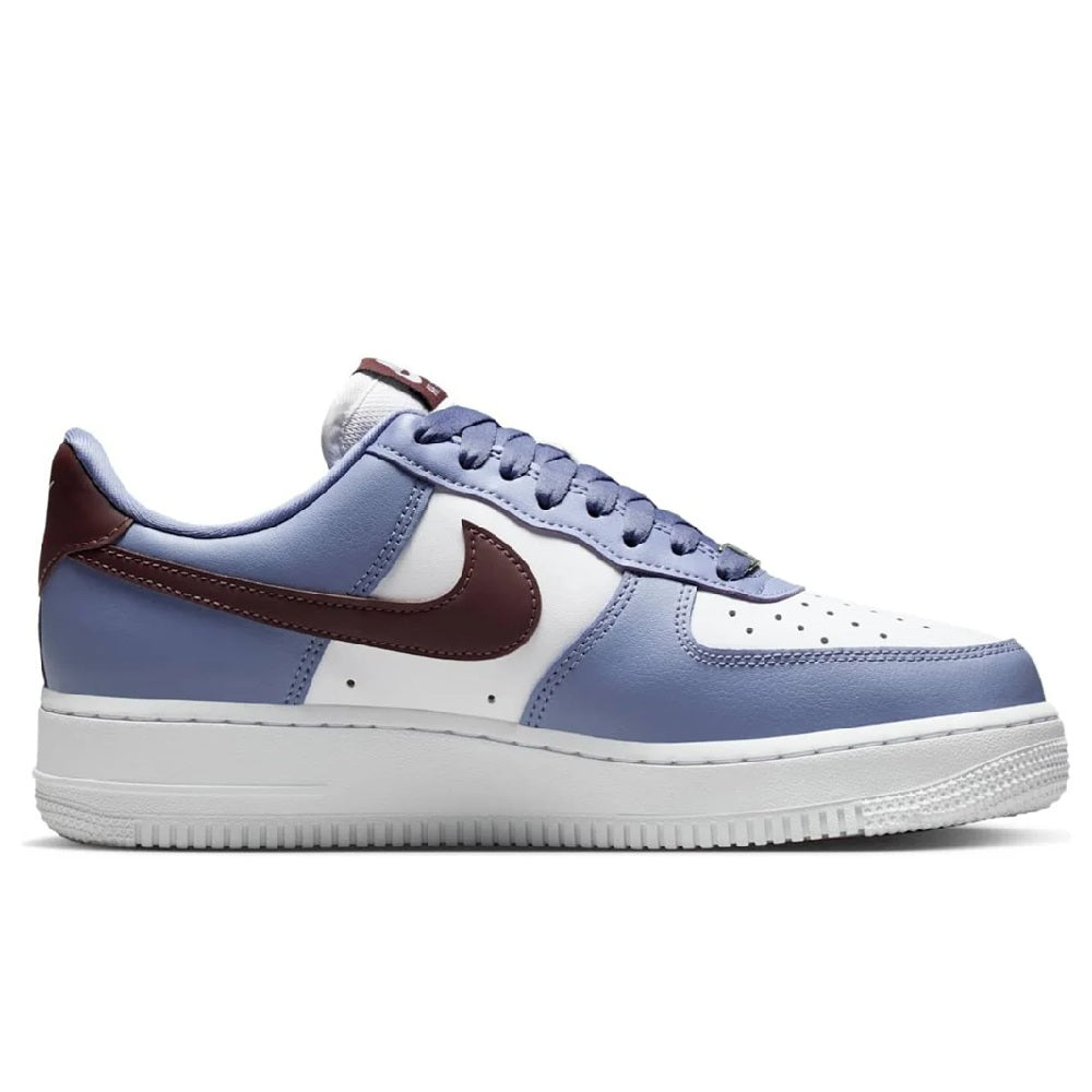 Low-top sneakers side view with blue leather, white toe panel, burgundy swoosh