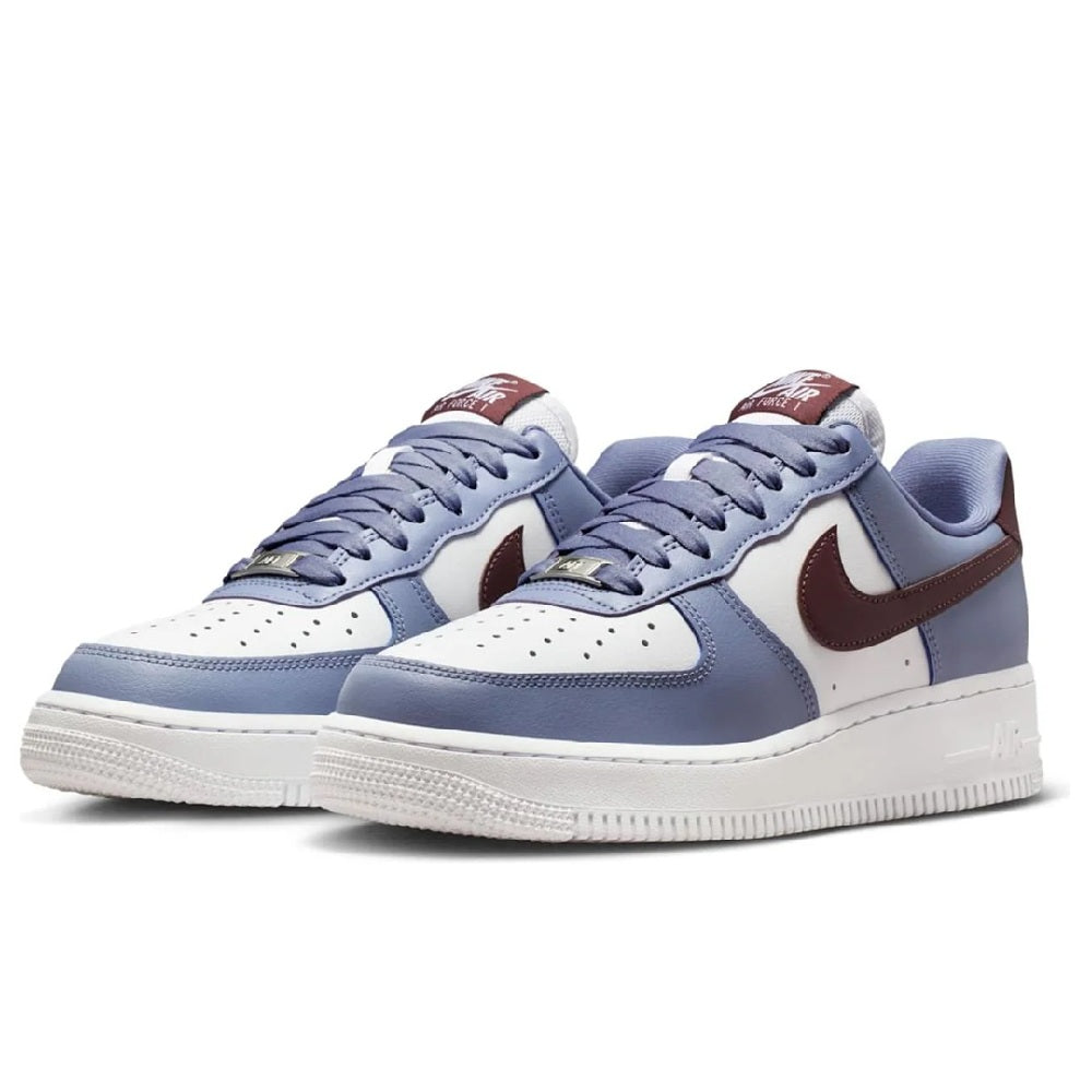 Pair of low-top sneakers with light blue uppers, white perforated toe, burgundy swooshes