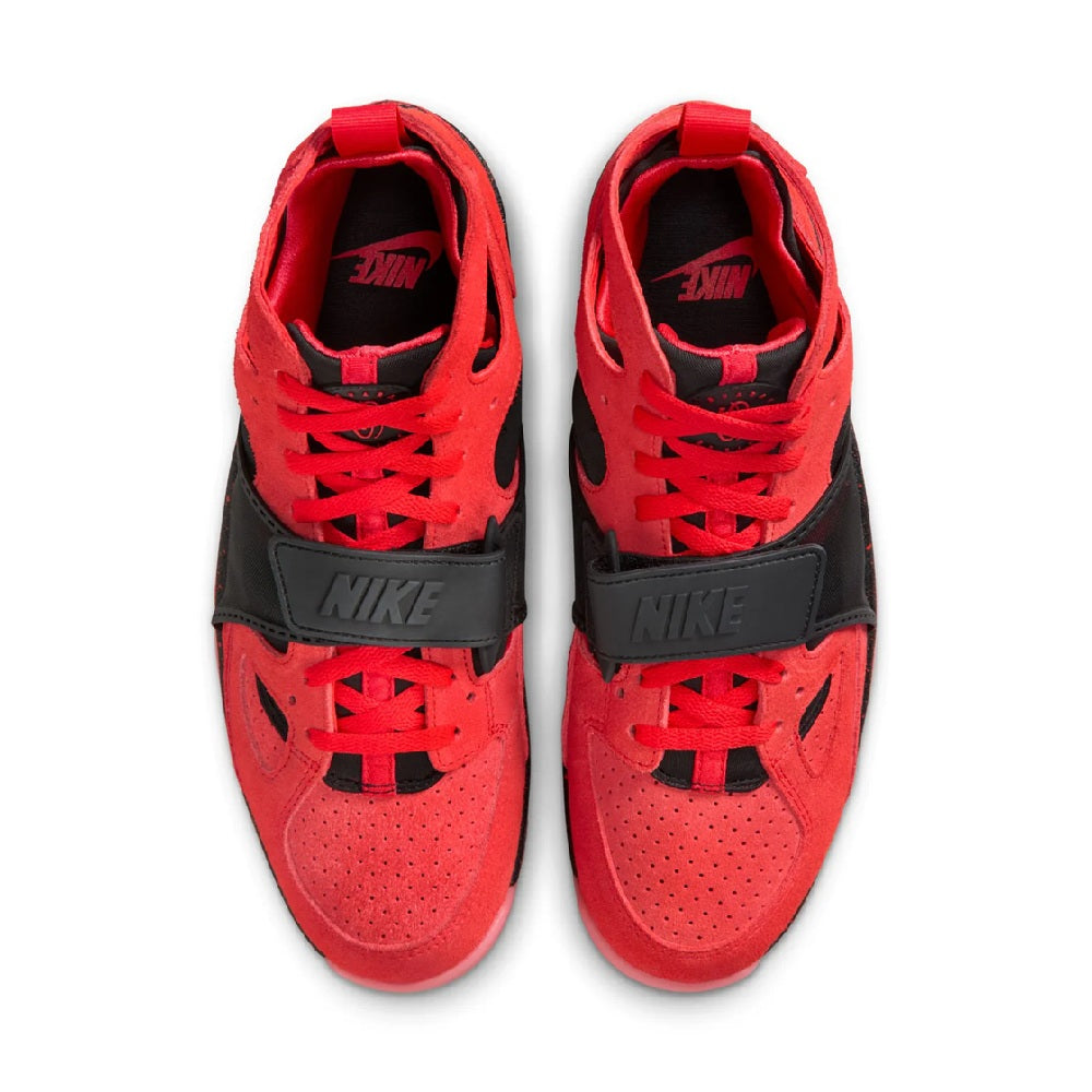 Red and black Nike sneakers with red laces, mesh lining, and black side strap