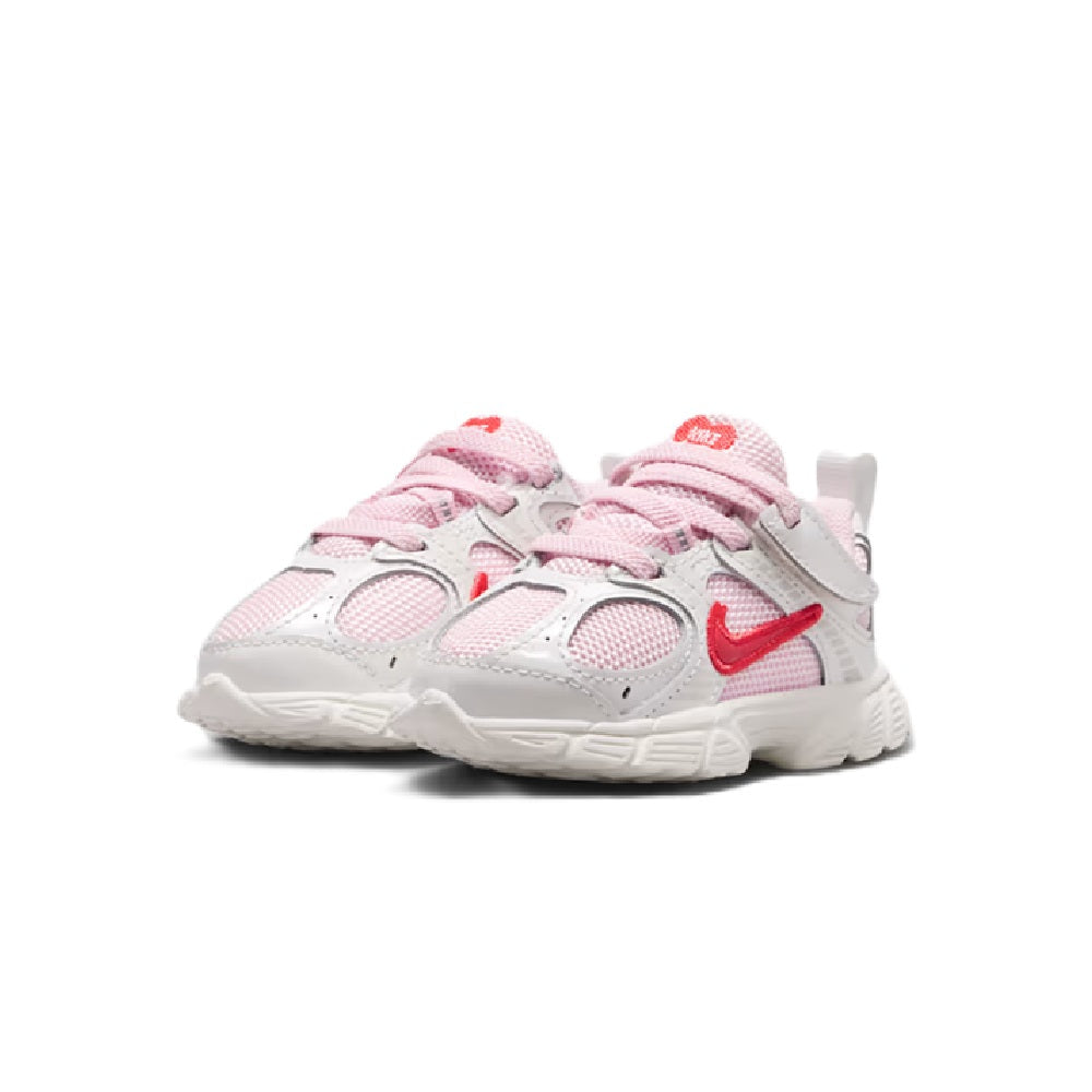 Kids' Nike running shoes, front view, pink-and-red details on white upper