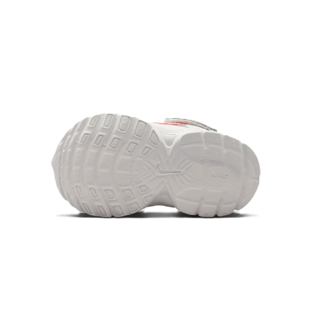 Kids' Nike running shoes outsole view, white rubber tread with arch support