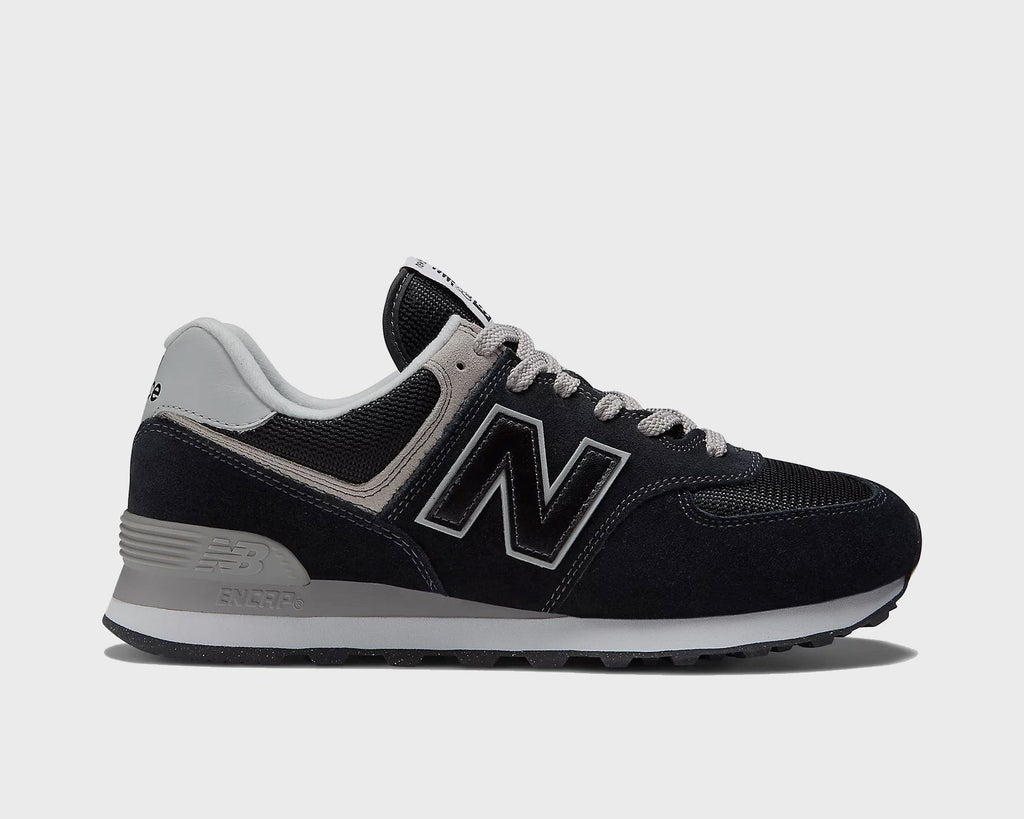 Black low-top sneakers with gray accents, white N logo, and rubber outsole