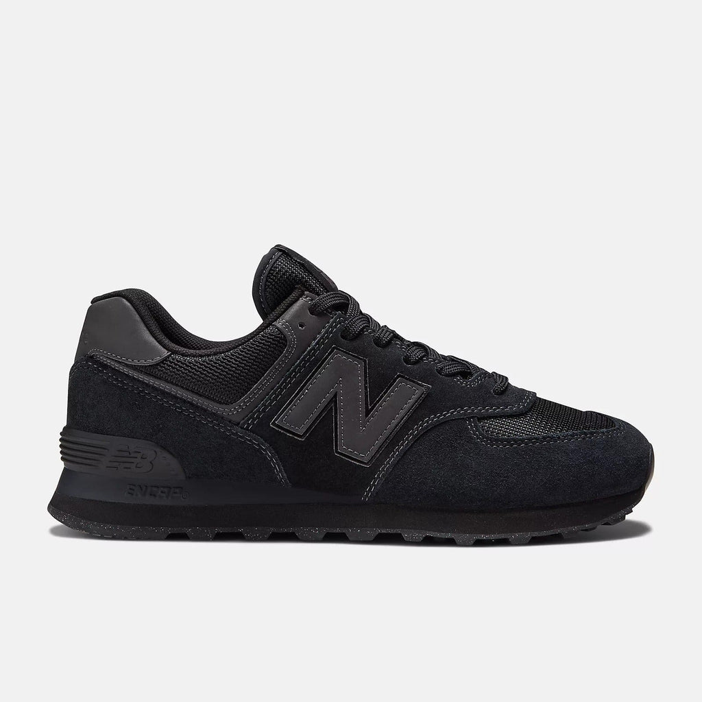 Black lace-up sneakers with dark suede upper, embossed N logo, and chunky sole