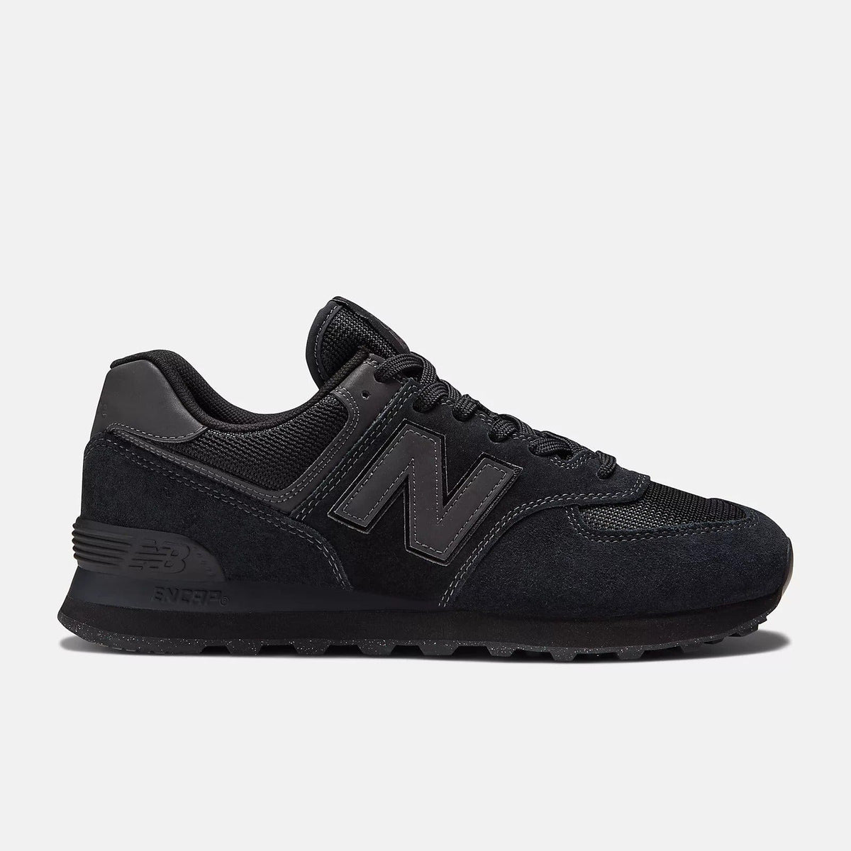 Black lace-up sneakers with dark suede upper, embossed N logo, and chunky sole