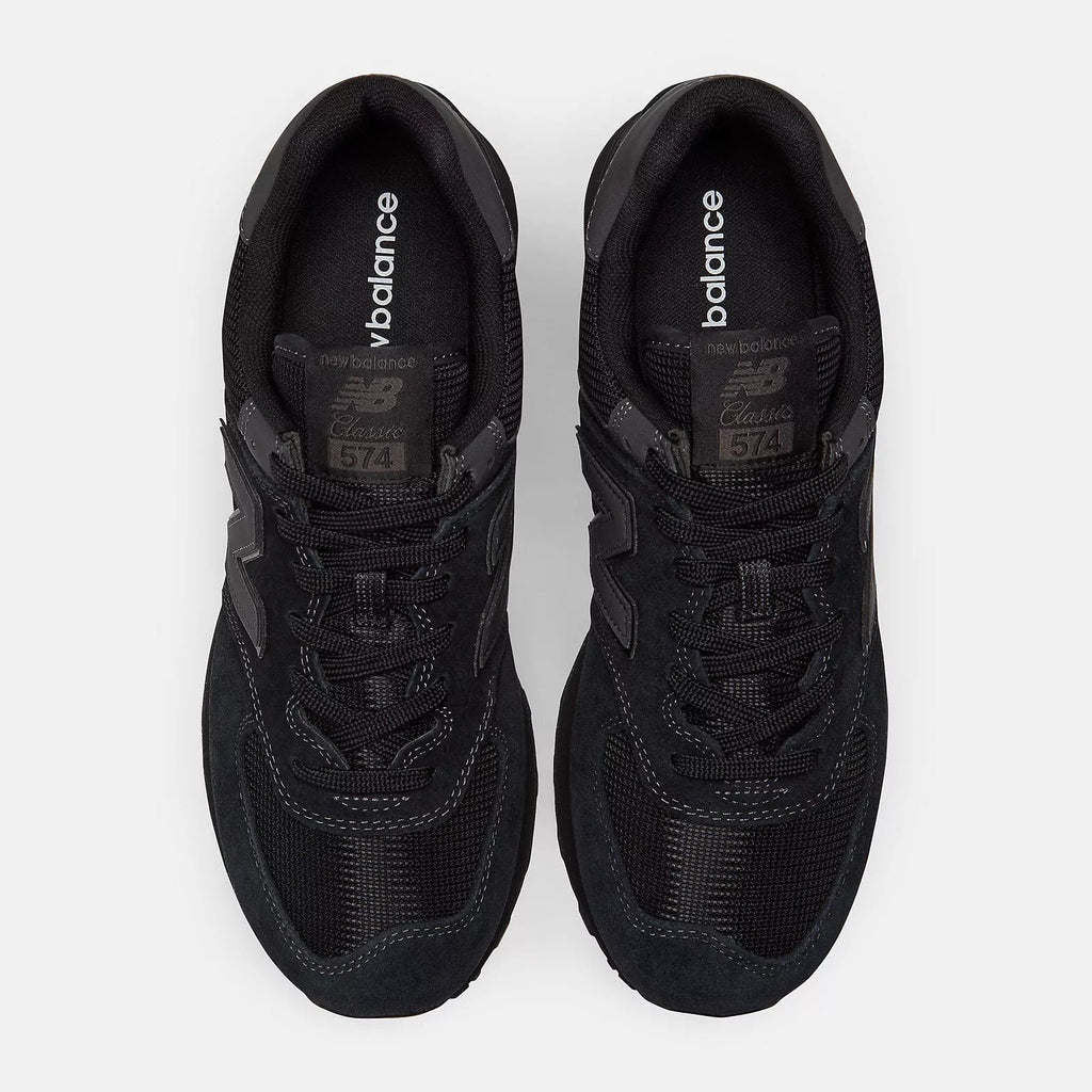 Black sneakers pair front view showing padded tongue and lace details inside