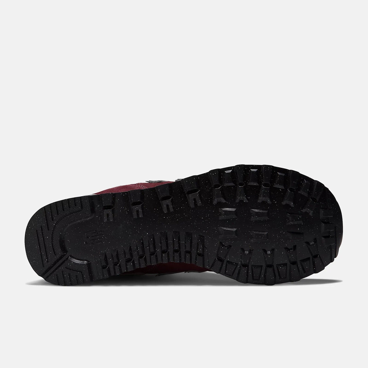 Burgundy sneaker outsole underside with black traction tread