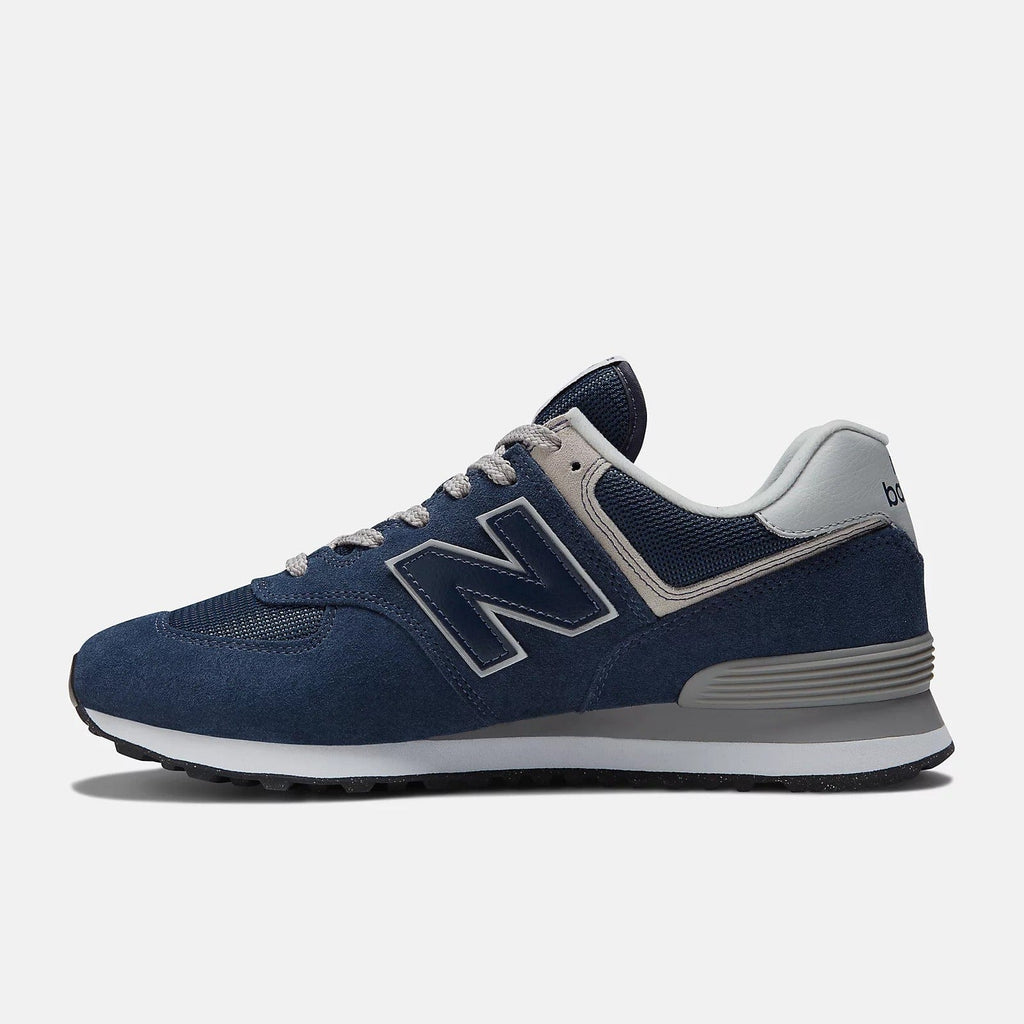 New Balance 574 sneakers in navy blue suede with light gray sole, side view
