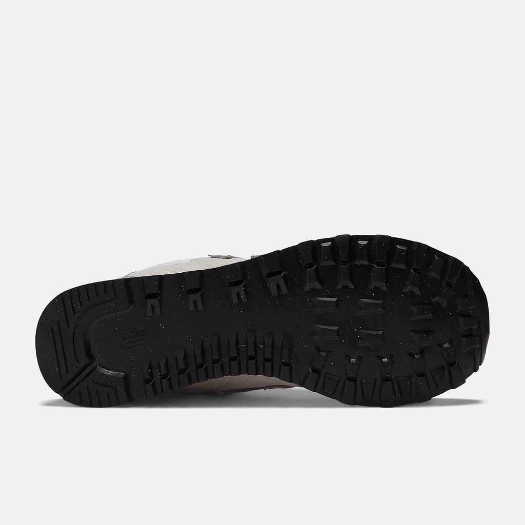Black sneaker outsole view with rugged tread pattern and traction nubs