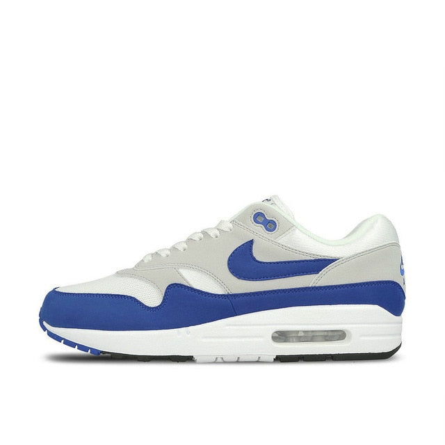 Nike Air Max 1 running shoe, white with blue swoosh and blue toe cap